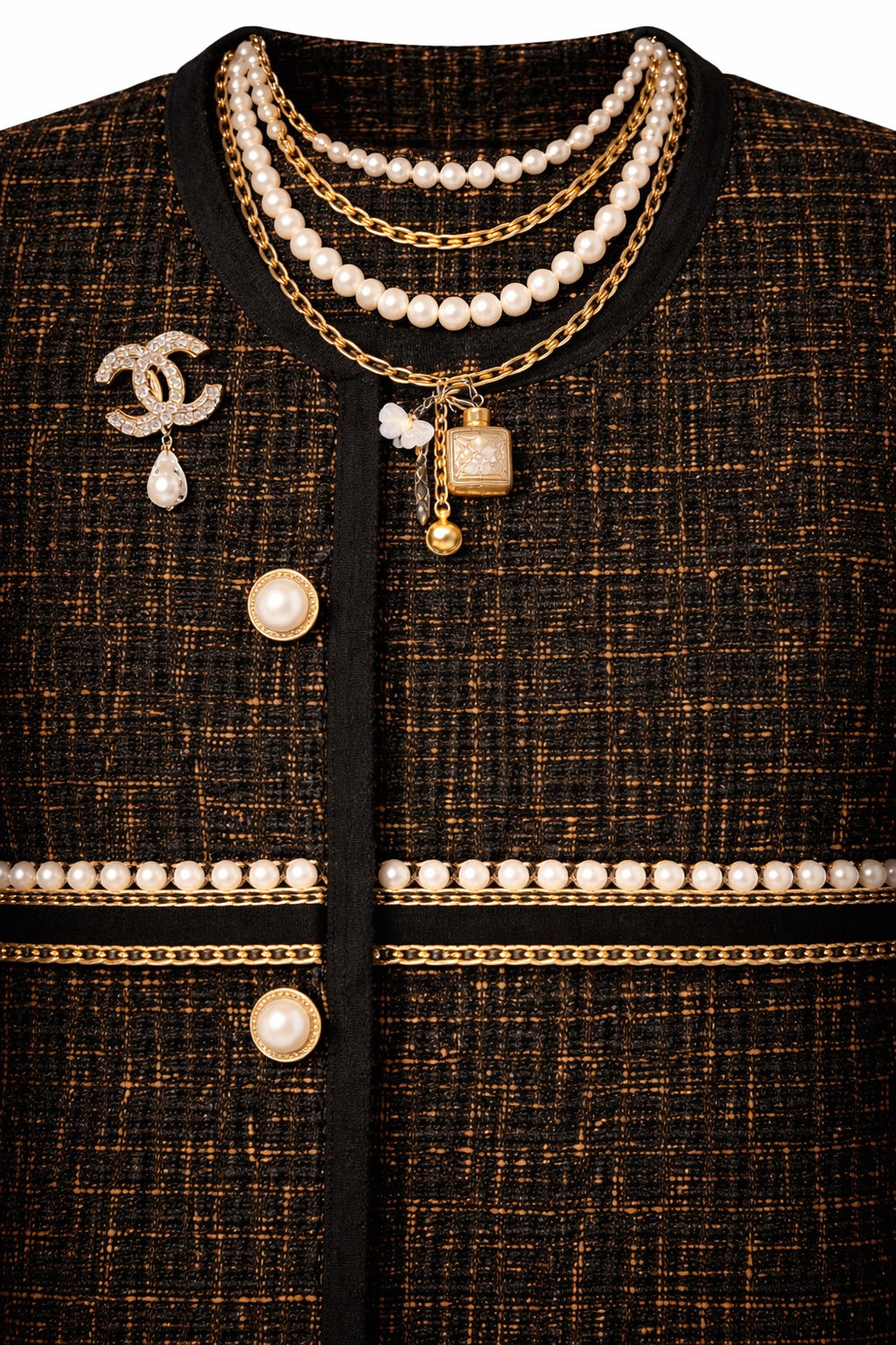Close-up of a black textured garment with pearl and gold jewelry details on a white background