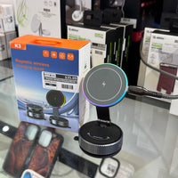 Photograph of a K3 Magnetic wireless charging stand featuring a colorful RGB light ring and a braided USB cable, displayed next to its orange and blue packaging with a $35.00 price tag on a glass retail counter