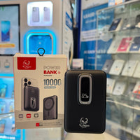 A black iPhoenix portable power bank with a silver-framed 22.5W digital display rests next to its white 10000mAh packaging on a reflective counter in a retail electronics store featuring a glowing blue CUSTOM CASE KIOSK and blurred shelves of phone accessories in the background