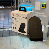 A MYBAT PRO PowerPerch wireless charger stand on a glass retail display, showing its white product box with a $30.00 price tag and "1 YEAR WARRANTY" badge, next to the black charger device, against a backdrop of a glowing blue light and "PREMIUM PROTECTION" text